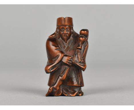 A Carved Wooden Netsuke in the Form of Elder with Staff, 6cms High