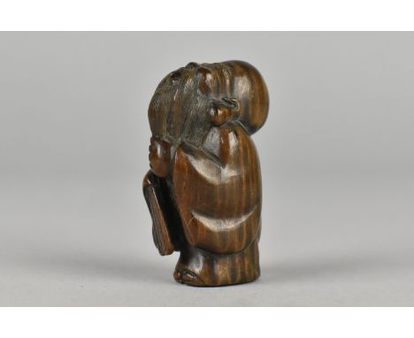 A Carved Wooden Netsuke depicting Elder with beard Looking to Heavens, Signed to Base, 5cms High