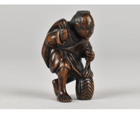 An Intricately Carved Wooden Netsuke Depicting Figure with Sack on Back, Signed Verso, 5cms High
