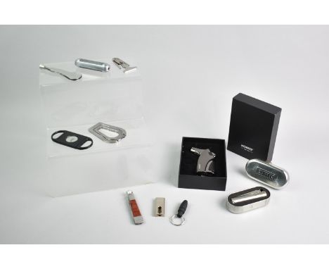 A Collection of Cigar Smoking Accessories to include Cutters, Kollea Lighter, Clipper Lighter, Pen Knives Etc (We Are Unable 