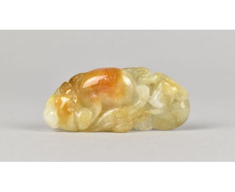 A Carved Jade Pebble decorated with Bat, Demon and Fruit, 5.25cms Long