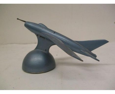 A mid 20th century blue enamelled cast metal table lighter, fashioned as a Lighting Fighter aircraft with the nose activating