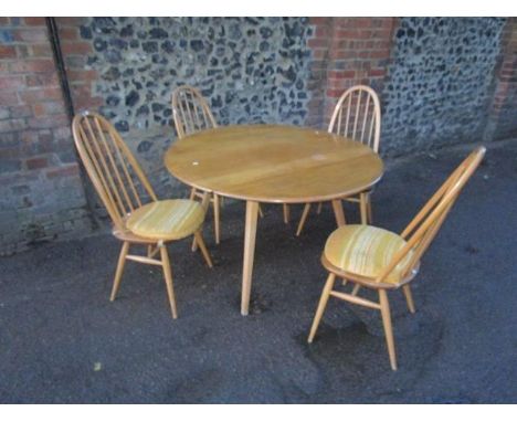 An Ercol Windsor light elm and beech drop flap dining table, model 384, 28 1/2" x 44 1/2" x 39 1/2" (when extended), along wi