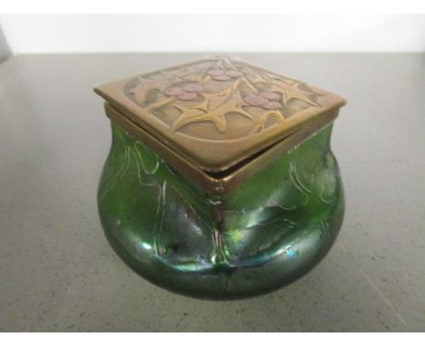 An Art Nouveau Kralik iridescent glass ink well, circa 1905, with a brass and copper collar and lid decorated with holly leav