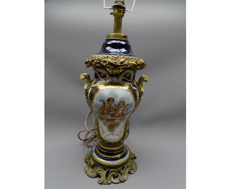 TABLE LAMP. Continental porcelain and ormolu, deep blue ground with ribbon and scrolled handles and centre cherubic panel, 38