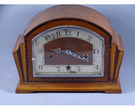 MANTLE CLOCK- a dome topped mahogany and chrome striking clock (damaged areas to dial)