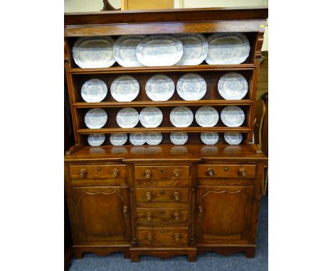 WELSH DRESSER. LATE 9TH CENTURY PINE AND MAHOGANY with 3-shelf rack over a breakfront base of 3 open top drawers and 3 blind 