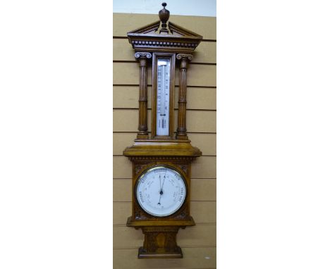 WALL BAROMETER. IN FINE QUALITY OAK OF PILLARED architectural design with mercury thermometer and circular dial. 104 cms high