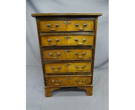 WALNUT REPRODUCTION CHEST of 5 drawers with brass swan-neck handles and on bracket supports, 50cms wide, 70 cms high 