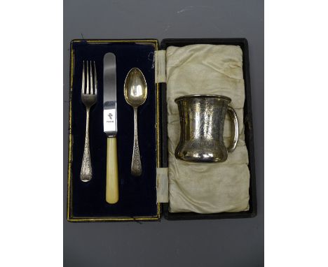 SILVER MUG, slightly waisted with scrolled decoration, 1.6 ounces, marks indistinct and a cased silver spoon, knife (missing)