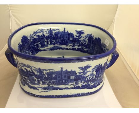 A blue and white ceramic footbath