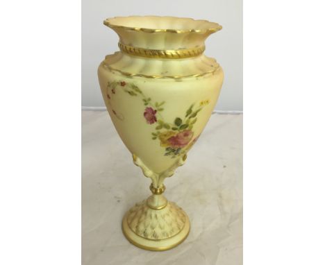 A Royal Worcester vase of urn form, with crimped border and raised on four claws with gold painted nails and a spread foot