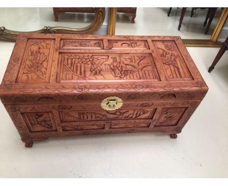 A carved Oriental wooden trunk