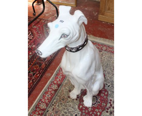 A large ceramic model of a seated greyhound, 90cm high
