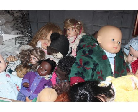 A collection of dolls; including an SUR composition head baby doll in hand knitted blue outfit, a ADG lifelike collectors bab