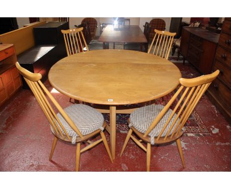 An Ercol elm dining table and a set of four stick back dining chairs 