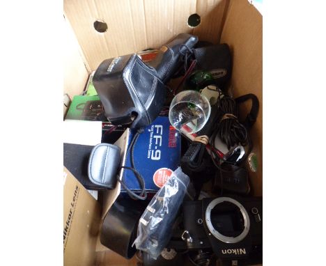 A Box Containing Various Camera Bodies and Accessories