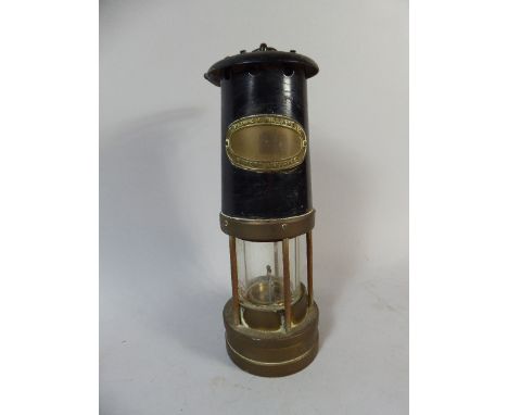 A Brass and Iron Miners Safety Lamp by Thomas and Williams Ltd