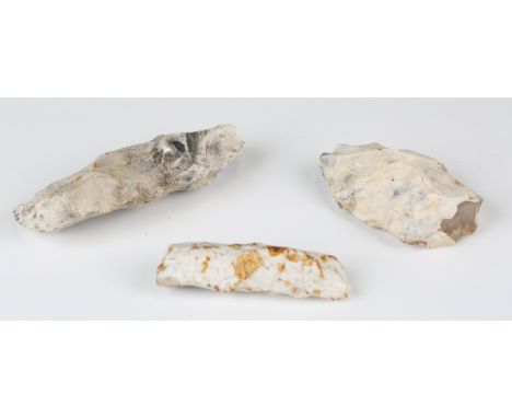 A Mesolithic tranchet axe, detailed 'Cissbury Vineyard Hill 8/4/72', length 13.5cm, together with another similar example and