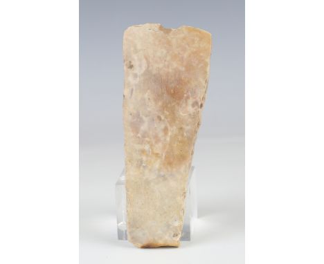 A Danish Neolithic polished stone axe head of pale cream tone, length 15cm.Buyer’s Premium 29.4% (including VAT @ 20%) of the