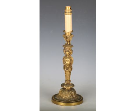 A late 19th century Neoclassical Revival gilt bronze candlestick, converted to a table lamp, the stem formed as three figural