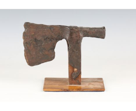 A Medieval iron carpenter's axe head, possibly 13th-15th century, mounted on a wooden stand, length 18cm.Buyer’s Premium 29.4