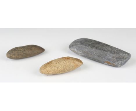 A group of three ancient stone axe heads, length of longest 13cm.Buyer’s Premium 29.4% (including VAT @ 20%) of the hammer pr