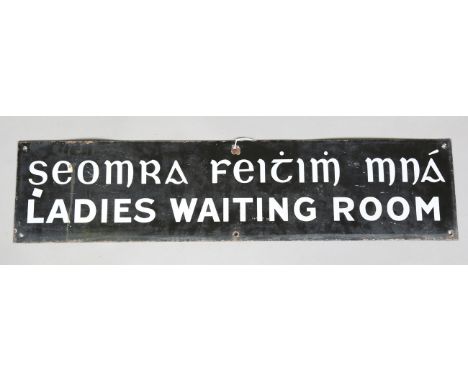 An Irish enamel 'Ladies Waiting Room' sign, also detailed in Gaelic, 93cm x 21.5cm.Buyer’s Premium 29.4% (including VAT @ 20%