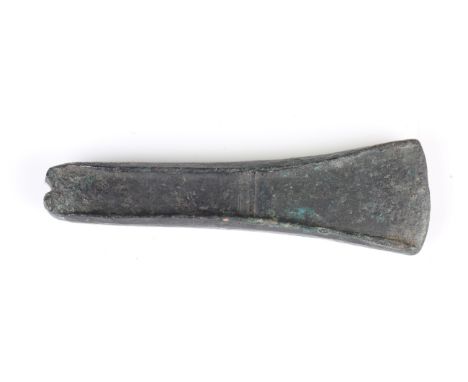 A small British Bronze Age early form axe chisel with flanged sides, length 9.5cm.Buyer’s Premium 29.4% (including VAT @ 20%)