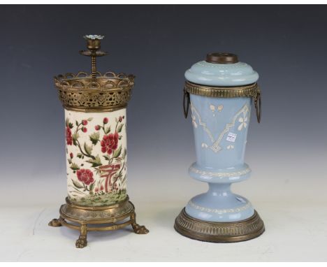 A 19th century Aesthetic Movement pottery and brass mounted oil lamp base, hand painted with flowers against a cream ground a