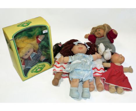A boxed Cabbage Patch Kids doll, together with five other Cabbage Patch Kids dolls