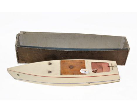 An early 20th century Kellner clockwork speedboat, with red and blue stripes on cream body, 'K' trademark decals, and measuri