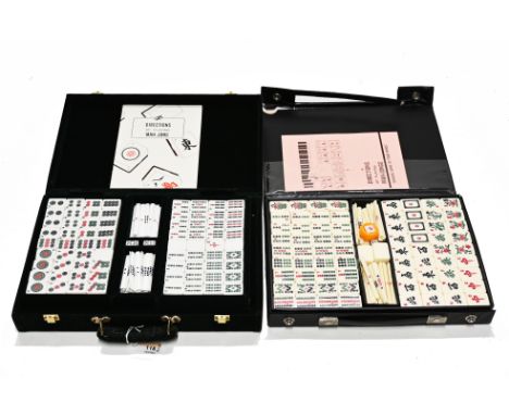 Two traditional cased Mahjong sets, one displayed in a green fabric case labelled Gino Ferrari