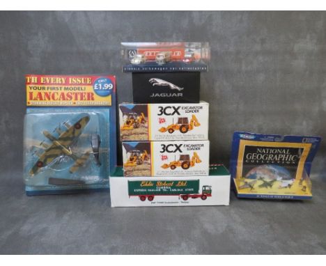 A MIXED TRAY OF BOXED AND CARDED DIECAST MODELS, to include 2 x JCB 3CX excavator loader, DAF F200 curtain side Eddie Stobart