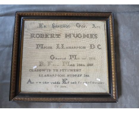 AN UNUSUAL 19TH CENTURY WELSH MEMORIAL SAMPLER, named for Robert Hughes, dated 1897, in original black and gilt frame, frame 