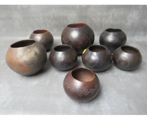 A COLLECTION OF EIGHT SOUTH AFRICAN ZULU TRIBAL ART BEER CONTAINER POTS, in various sizes, some with painted and incised deco