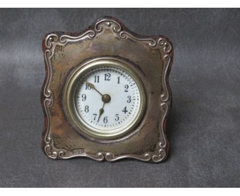 A HALLMARKED SILVER EASEL CLOCK, Chester 1919, 10 x 10 cmCondition: Back cover is a little loose. Ticks on winding however wo
