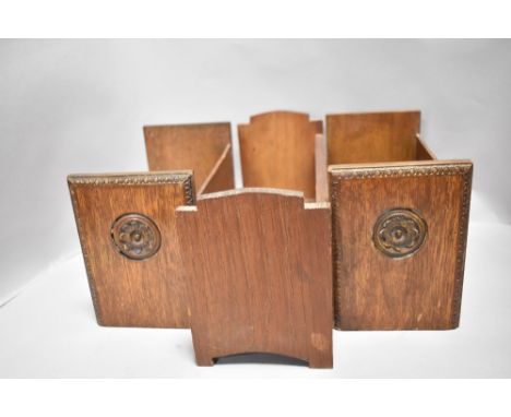 Three early 20th century book shelf or troughs all made in oak including a matching pair having carved leaf to ends