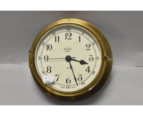A 20th century St James London ships style port hole clock having brass case