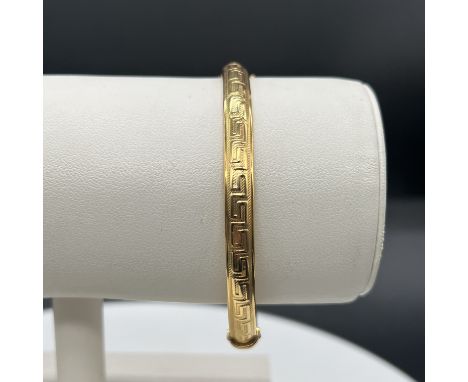 9ct yellow gold Greek design bangle,
no metal inner core,
bangle has dents on one side,
weight is 4.69 grams