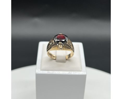 A 9ct yellow gold gents gypsy gernet ring with diamond shoulders,
size S,
weight 7 grams
