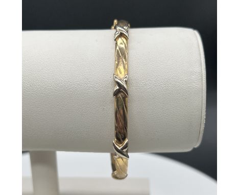 9ct yellow and white gold bangle,
6.7grams in weight,
