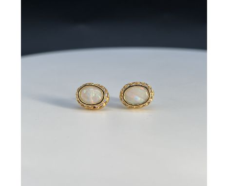 A pair of 9ct yellow gold opal earrings,
stones are 10mm x 7mm,
1.6 grams in weight