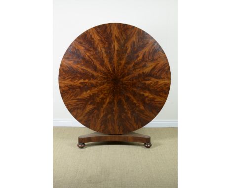 A 19th Century circular mahogany Breakfast Table with radial veneer on tapering hexagonal column support with triform base, 4