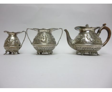 A Victorian silver three piece Tea Service embossed flowers and mythological figures, etc, vacant cartouches, shaped feet, Lo