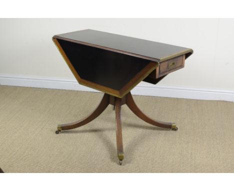 A 19th Century mahogany and brass edged dropleaf Campaign Library Table of octagonal form, with inset writing surface, fitted