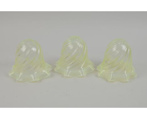 A set of three vaseline glass Lamp Shades with swirled design and wavy rims, 5in H