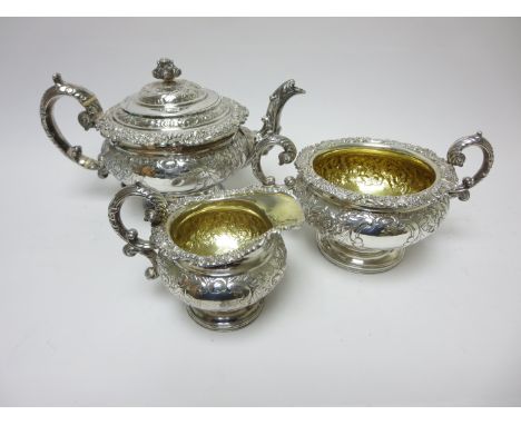 A George IV Scottish silver three piece Tea Service with floral embossing and vacant cartouches, Edinburgh 1825, maker: A.E, 