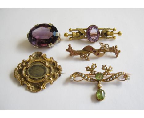 A Peridot and Seed Pearl Brooch, two Amethyst Brooches, a Ruby and Seed Pearl Bar Brooch and a Mourning Brooch enclosing lock