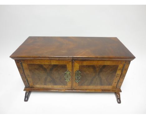 An 18th Century walnut and mahogany table top Cabinet with pair of cross-banded doors enclosing six small drawers containing 